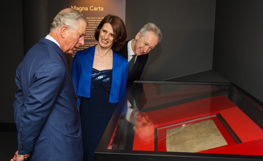 Britain's Prince Charles looks at an original Magna Carta manuscript during a visit to the British Library on March 12. The document, which has served as the foundation of the modern judicial system, was issued in 1215 by King John, who was under pressure from English barons. The exhibition marks the 800th anniversary of the document.