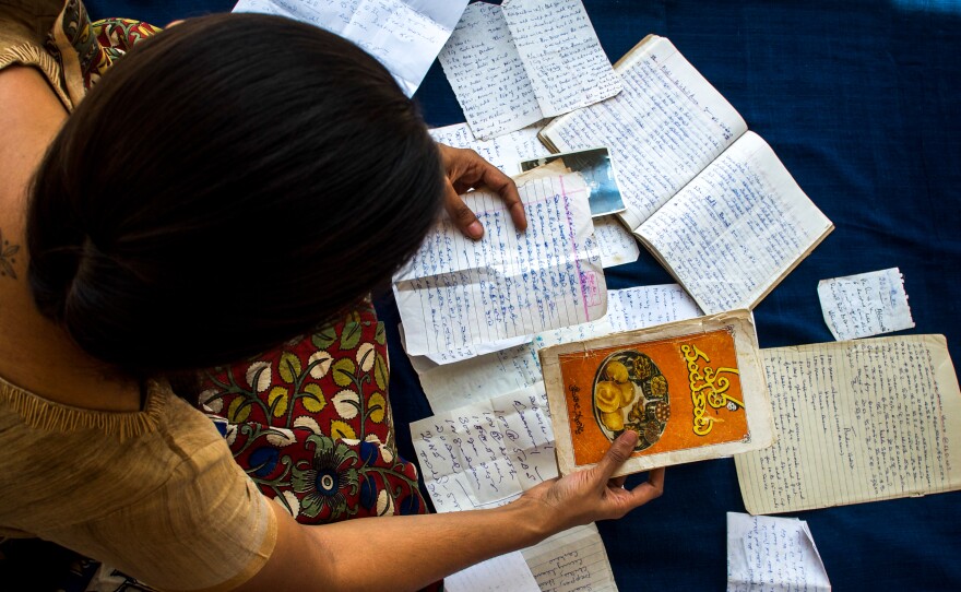 Archana Pidathala sorts through old recipes that belonged to her grandmother. "She never once complained or felt overwhelmed by the incredible amount of cooking she did for us," she says.
