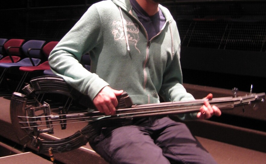 University of South Florida jazz performance student Zach Pedigo plays a bass made from shotgun barrels and magazines from AK-47s.