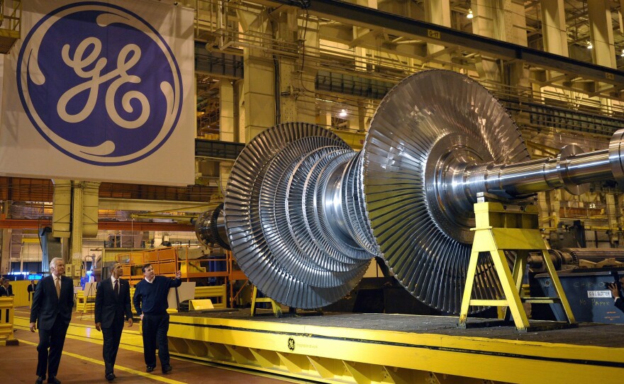President Barack Obama looks at a turbine during a tour in 2011 of the General Electric plant in Schenectady, N.Y., with then GE Chairman and CEO Jeffrey Immelt (left) and plant manager Kevin Sharkey.