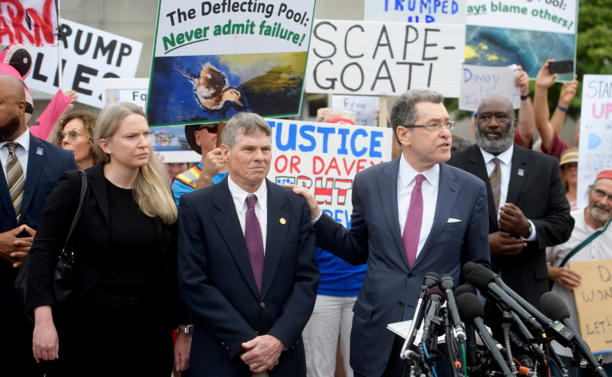 David Hearn (second from left) and his attorney Norman Eisen (right) addressed reporters after he entered his not guilty plea on July 9 in Washington, D.C.