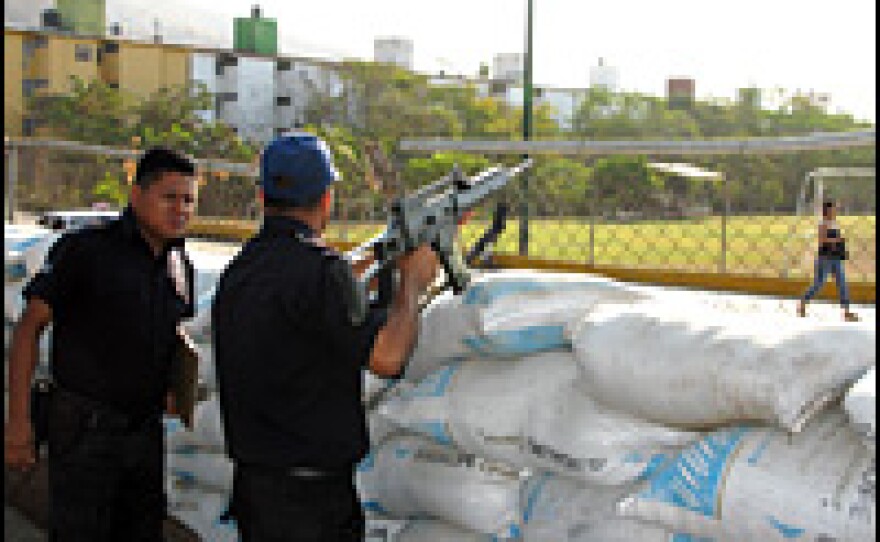 The police station in Zihuatanejo resembles a war zone: It's surrounded with sandbags, while officers with high-caliber rifles are stationed in pillboxes out front.