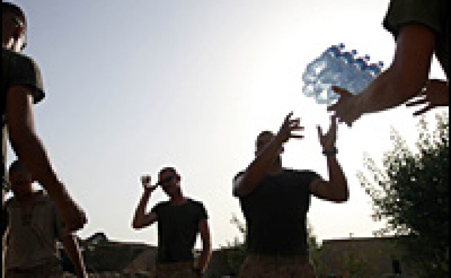 Marines from the 24th Marine Expeditionary Unit unload supplies of fresh drinking water at a base in southern Afghanistan's Helmand province.