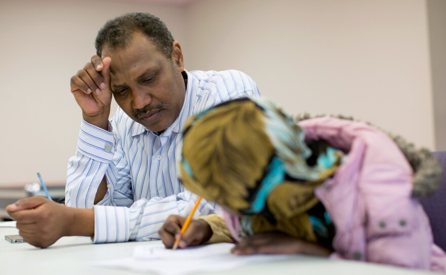 Shekhey helps a child with homework at the after-school program. Shekhey says he and his staff aim to help refugees feel at home. "We are like soldiers," he says. "We go do whatever's needed. No time sheets, no nothing. Just go."