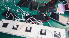 FILE - Phones are kept for charging at a Doctors Without Borders informal camp in Mardyck, northern France, Wednesday, July 2, 2025.
