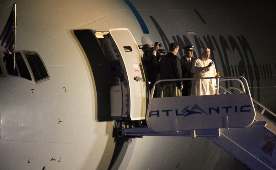 Pope Francis waves to the crowd at Philadelphia International Airport before departing for Rome on Sunday evening.