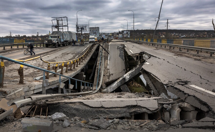 <strong>April 20:</strong> A Ukrainian Army truck stops at a war-damaged bridge in Bucha, Ukraine. Ukrainian soldiers are busy reconnecting suburbs of Kiev more than a month after Russian troops invaded the area.