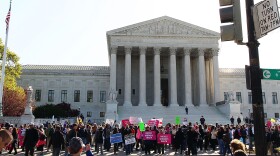 People participate in a protest on the second day of oral arguments for the Patient Protection and Affordable Care Act in front of the U.S. Supreme Court building on March 27, 2012 in Washington, DC.