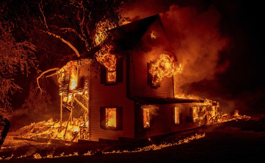 A home burns on Jeters Road as the Dixie fire jumps Highway 395 south of Janesville, Calif., on Monday, Aug. 16, 2021.