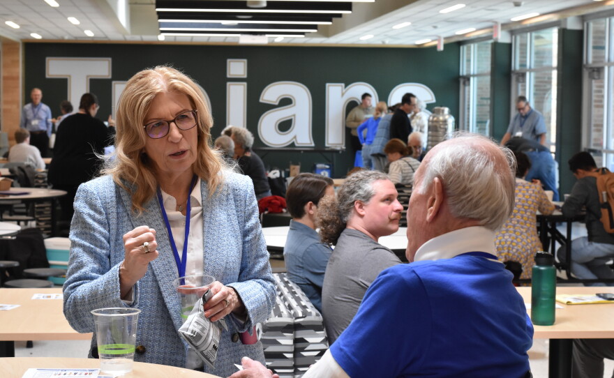 Iowa Democratic Party Chair Rita Hart (left) speaks with volunteers at the 1st Congressional District Convention in Iowa City, Iowa May 2, 2026.