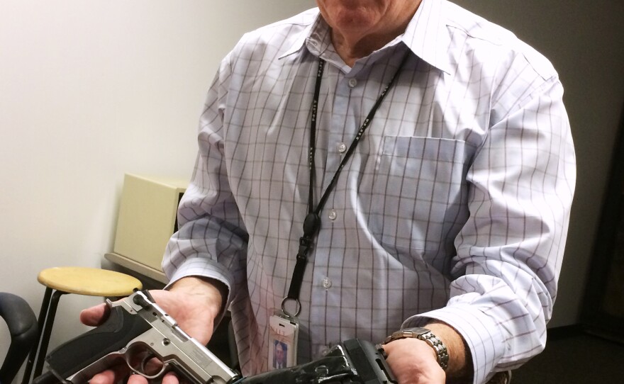 William Marshall of the New Jersey Institute of Technology with two specially modified guns used for research on grip sensor technology.