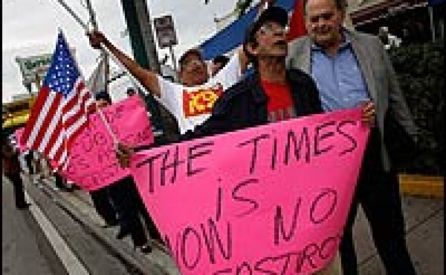 Oscar Gala holds a sign that reads "The times is now No Castro" in the Little Havana neighborhood of Miami, Fla., as he reacts to the news that Cuban President Fidel Castro said he won't accept a new term in office.