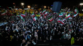 Demonstrators wave Iranian flags and flags of Lebanon's militant Hezbollah group during a pro-government gathering at Islamic Revolution Square in Tehran, Iran, Saturday, May 30, 2026.