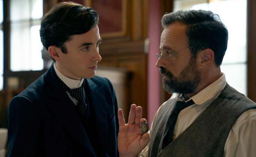 Oskar (Juergen Maurer, right) shows Max (Matthew Beard), a casino token found in the belongings of a murder victim. VIENNA BLOOD Season 4