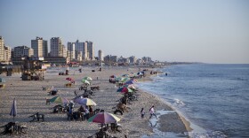 Families and friends enjoy their time on a Gaza City beach. Israel allows in international aid workers, journalists and diplomats, but tourists are prohibited.