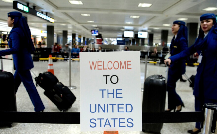 A sign at Washington Dulles International Airport welcomes travelers. A three-judge panel decided not to reinstate President Trump's travel ban barring travelers from seven majority-Muslim nations.