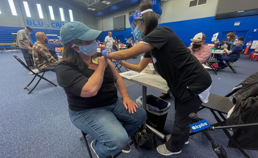 A woman is vaccinated at the COVID-19 vaccination site at CSU San Marcos. Feb. 22, 2021.