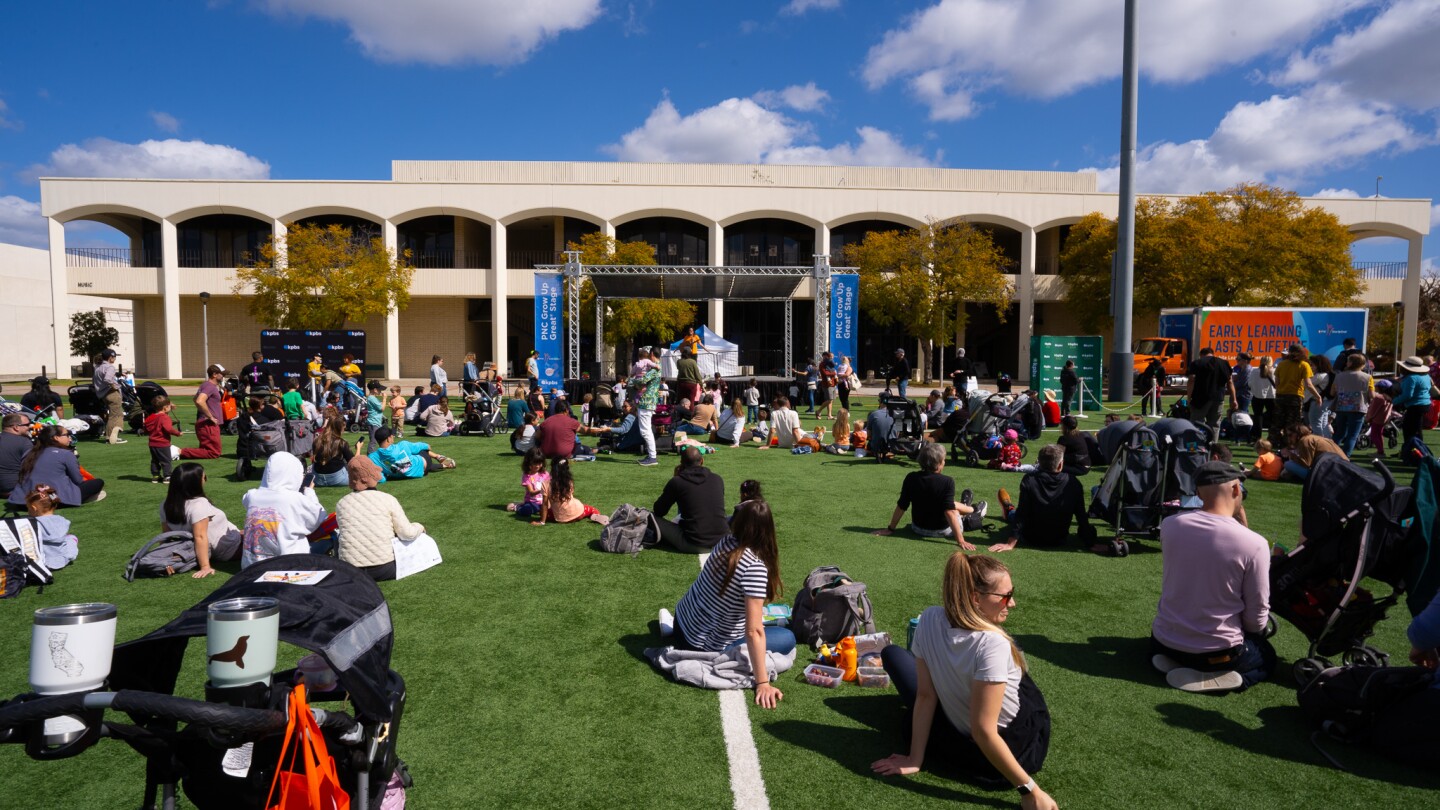 Families sing and dance with Ralph of Ralph's World at Be My Neighbor Day across the street from the KPBS station on Saturday, April 6 in San Diego, CA.