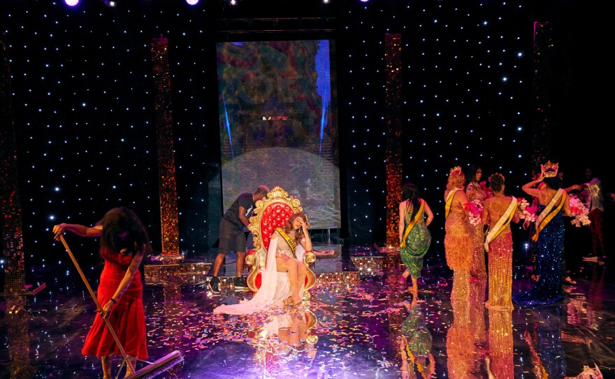 Miss saHHara (bottom left) sweeps the stage as an Chedino slumps on the Queen's throne during a foot-numbing five-hour crowning marathon on the pageant's final full day, during which each contestant experienced being crowned queen.