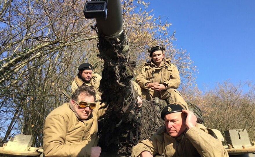 James Holland and Jim Clarke converse atop Clarke’s restored and operational Sherman Tank. 