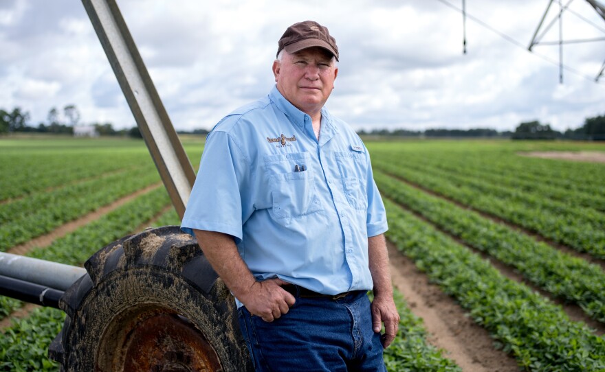 Mike Newberry stands next to the center pivot irrigation system that waters his peanut crop. A fourth-generation farmer, he is the last in his family to farm. His only child, a daughter, has a career as a physical therapist.