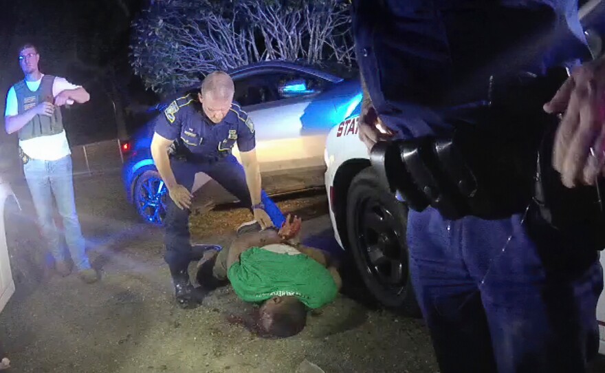FILE — This image from video from Louisiana state trooper Lt. John Clary's body-worn camera shows trooper Kory York standing over Ronald Greene on his stomach on May 10, 2019, outside of Monroe, La.