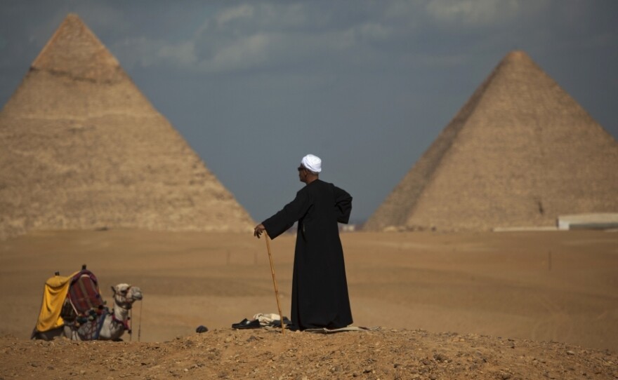 Egyptian camel driver Gamal, 54, waits for tourists near the pyramids, in Giza, Egypt, Jan. 31.