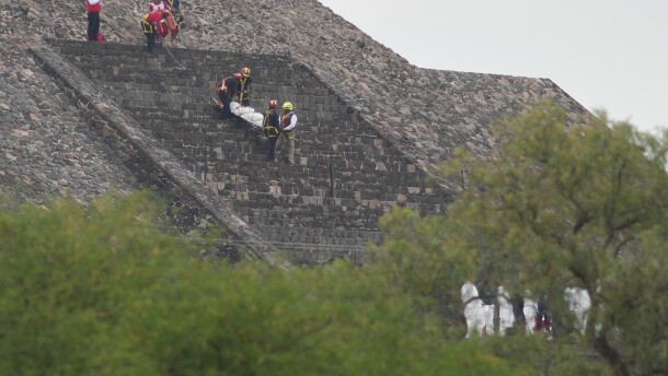 Forensic workers carry the body of a victim down a pyramid after authorities said a gunman opened fire, in Teotihuacan, Mexico, Monday, April 20, 2026.