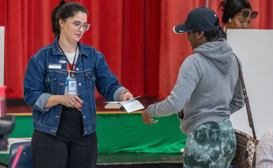 Poll workers assist voters on Super Tuesday at the First Ward Creative Academy, Mecklenburg County Precinct 13 on March 5, 2024 in Charlotte, North Carolina.