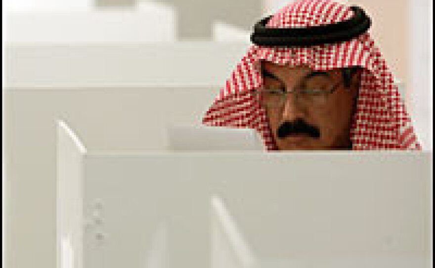 A man reads through ballot paper before casting his vote in Riyadh on Feb. 10.