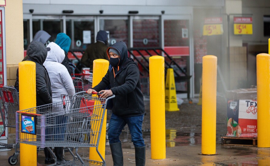 People wait in long lines at an H-E-B grocery store in Austin, Texas, on Wednesday. The large supermarket chain said the "unprecedented weather event in Texas has caused a severe disruption in the food supply chain."