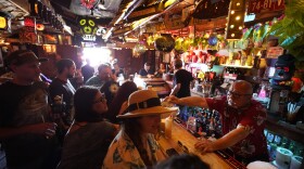 In this Wednesday, July 7, 2021, file photo, patrons enjoy cold tropical cocktails in the tiny interior of the Tiki-Ti bar as it reopens on Sunset Boulevard in Los Angeles.