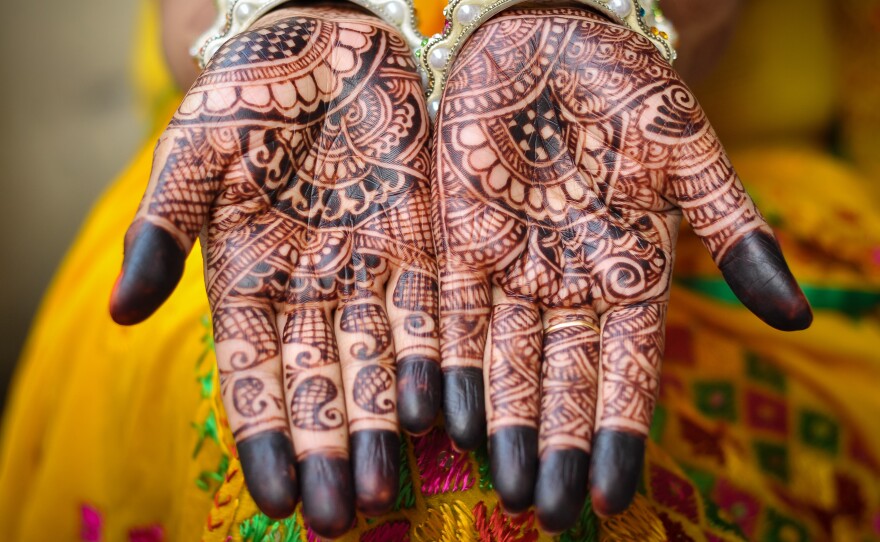 Henna tattoos decorate a bride's hands. A new ruling by the Supreme Court of India says that sex with any underage girl, even if she's a bride, is considered an act of rape. So child brides age 15 to 18 now have the same legal protection that younger girls do.