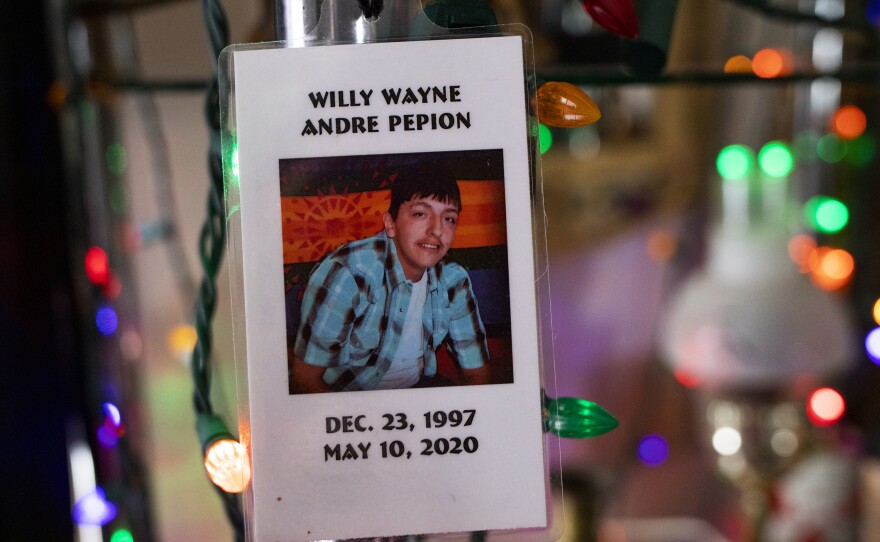 Willy Pepion's memorial card hangs from a shelf at his mother Wilma Fleury's home on the Blackfeet Indian Reservation in Montana.