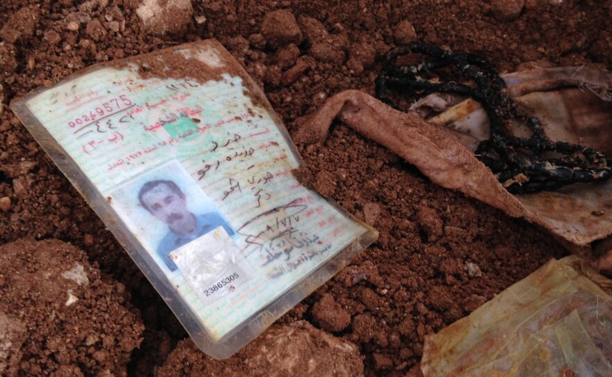 An identification card lies in the dirt in Hardan village on Dec. 22, 2014.