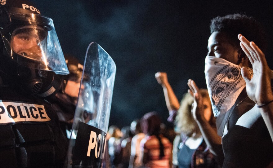 Police officers face off with protesters on Interstate 85 in Charlotte, N.C., during demonstrations following the death of a man shot by a police officer on Tuesday.