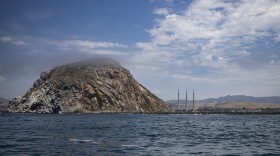 Afternoon fog slowly covers Morro Rock, a major landmark in Morro Bay. The federal government has leased 376 square miles of oceans waters off Morro Bay for floating wind farms.