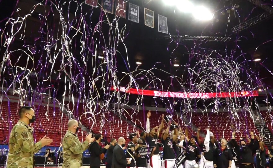 San Diego State men's basketball team hoisting up the Mountain West Conference Tournament trophy after beating Utah State, 68-57, on March 13, 2021.