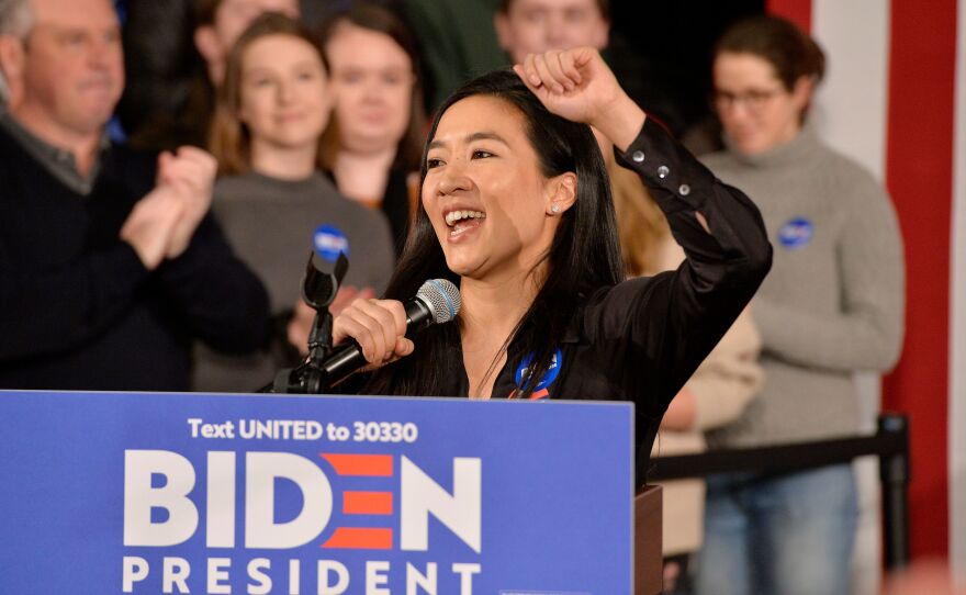 Former Olympian Michelle Kwan speaks before then-candidate Joe Biden at a rally in Manchester, N.H., on Feb. 8, 2020. On Wednesday President Biden said he'll nominate Kwan for ambassador to Belize.