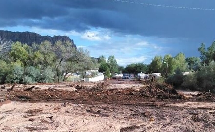 Debris and water cover the ground in Hildale, Utah, where a flood ripped through the town Monday.