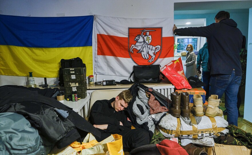 A volunteer sleeps in the Belarusian House, a cultural center in Warsaw, while waiting to leave for Ukraine. Many Belarusians have come to enlist in a battalion named after Kastus Kalinouski, a writer and revolutionary who was the driving force behind Belarusian nationalism in the 19th century.