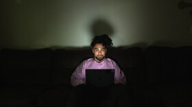 Jodeah Wilson, 22, on his laptop at his off-campus apartment near Sacramento State University on Oct. 17, 2025. Wilson, a former Sac State student, left school this semester after being unable to afford tuition.