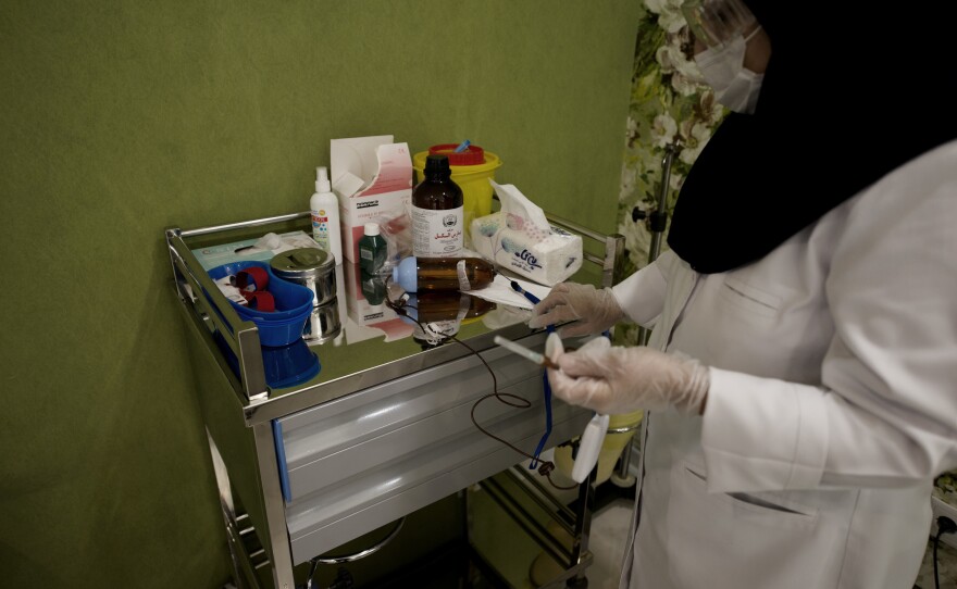 A nurse prepares chemotherapy medications for patients at the Roshana Cancer Center. An oncologist there says the limitation goes beyond goods and supplies.
