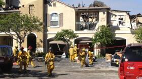 Firefighters attend to burned-out condo complex in Carlsbad, May 16, 2014.