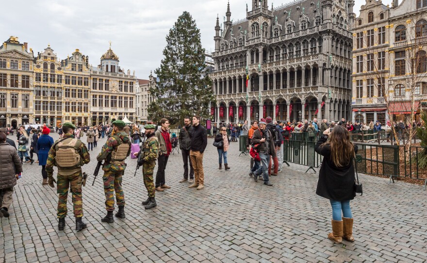 Soldiers patrol outside the Grand Place in Brussels on Tuesday. Police arrested two people on suspicion of planning attacks at tourist spots in the city over the holidays.