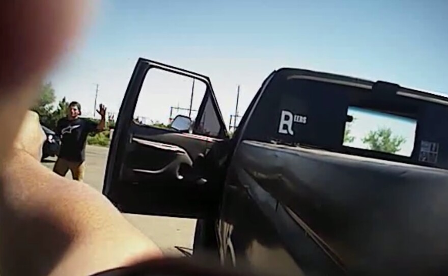 In this image made from a June 25 police body-camera video released by Fresno Police Department, a police officer points a gun at Dylan Noble in Fresno, Calif.