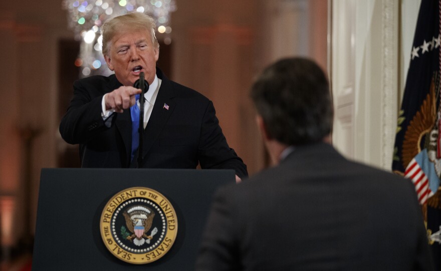 President Donald Trump speaks to CNN journalist Jim Acosta during a news conference in the East Room of the White House in Washington.