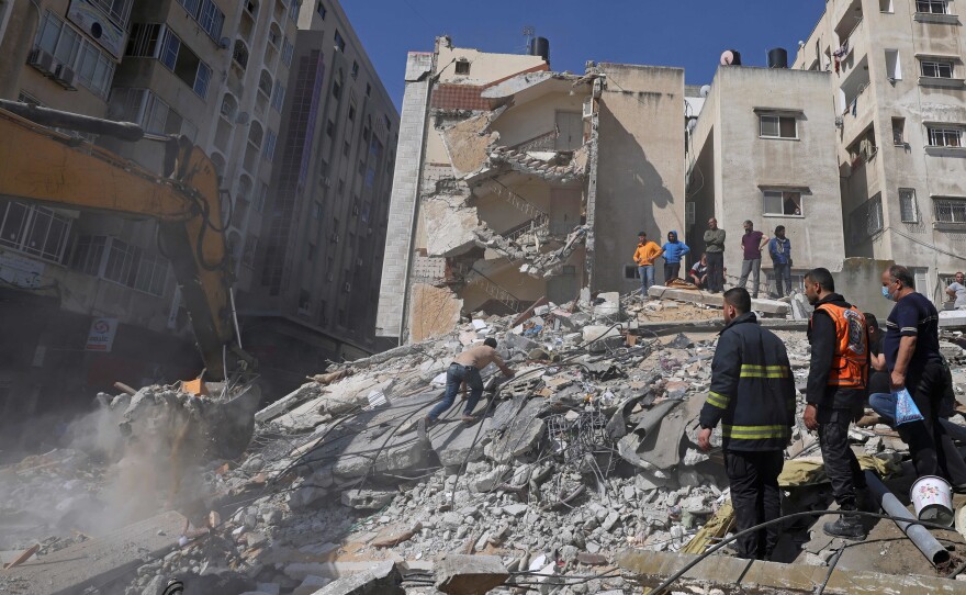 People search for victims under the rubble of a destroyed building in Gaza City's Rimal residential district on Sunday, following Israeli airstrikes.