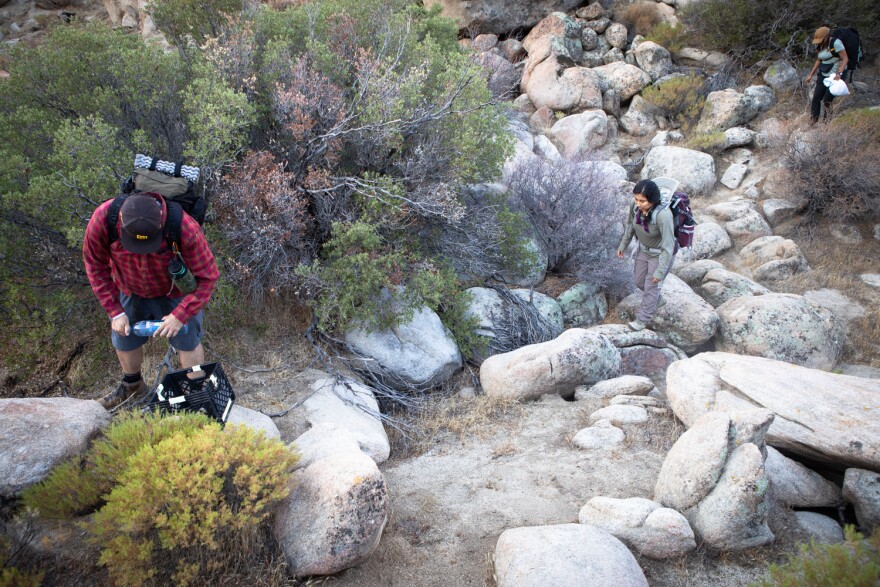 Members of the group Border Kindness drop water and other supplies for migrants in the Jacumba Wilderness, Aug. 13, 2022.