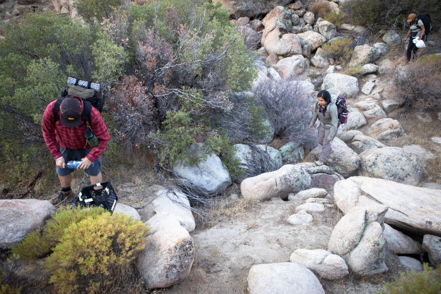 Members of the group Border Kindness drop water and other supplies for migrants in the Jacumba Wilderness, Aug. 13, 2022. 